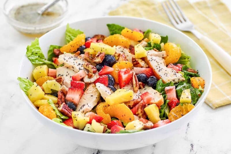 A bowl of copycat Panera strawberry poppyseed chicken salad and a fork by it.