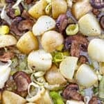 Oven roasted leeks and potatoes on a baking sheet.
