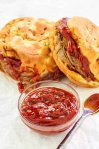 Copycat Arby's red ranch sauce and two roast beef sandwiches.