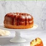 Bacardi rum cake on a cake stand and a slice on a plate.