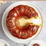 Bacardi rum cake on a plate and a slice next to it.