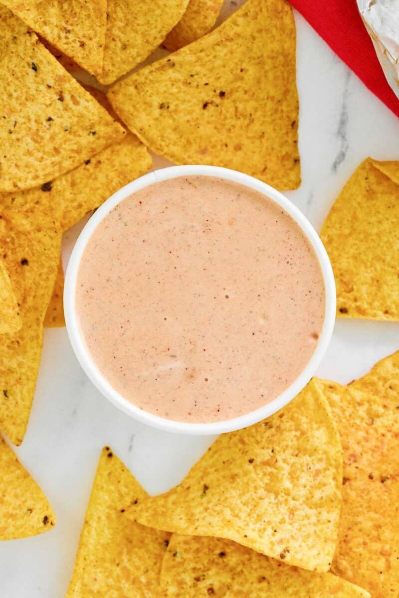 Copycat Chipotle adobo ranch in a bowl and corn tortilla chips around it.