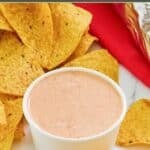 Homemade chipotle adobo ranch and tortilla chips on a marble surface.