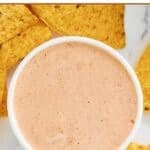 Homemade Chipotle adobo ranch in a bowl and tortilla chips around it.
