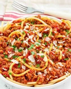 A bowl of copycat Olive Garden spicy three meat sauce with bucatini.
