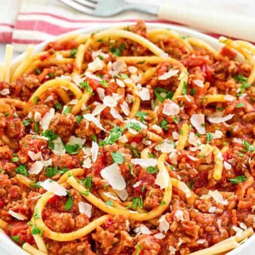 A bowl of copycat Olive Garden spicy three meat sauce with bucatini.