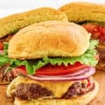 Homemade Smashburger classic smash burgers on a wood serving board.
