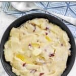 Homemade Cheesecake Factory mashed potatoes in a large bowl and a serving spoon by it.