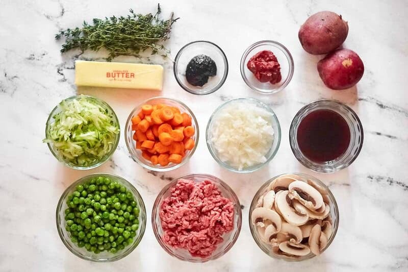 Copycat Cheesecake Factory shepherd's pie ingredients on a marble surface.