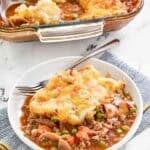Copycat Cheesecake Factory shepherd's pie serving on a plate and the pie in a baking dish.