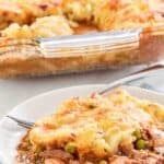 A serving of homemade Cheesecake Factory shepherd's pie on a plate and the pie behind it.
