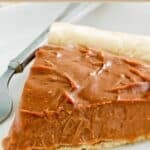 Homemade chocolate cream pie slice on a plate.