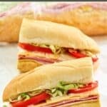 Homemade Kmart sub sandwich cut in half and one wrapped in plastic wrap.