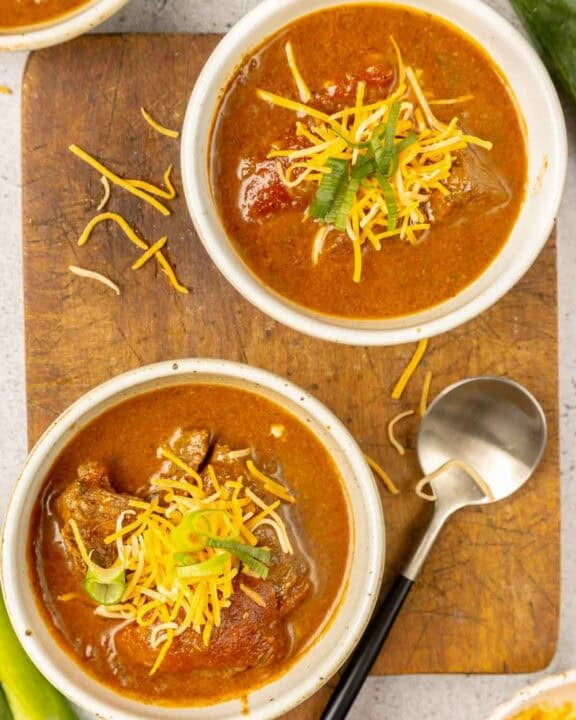 Lady Bird Johnson's Pedernales River chili in several bowls and a spoon next to them.