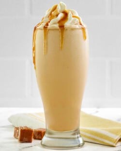 Copycat McDonald's caramel frappe drink on a marble surface.
