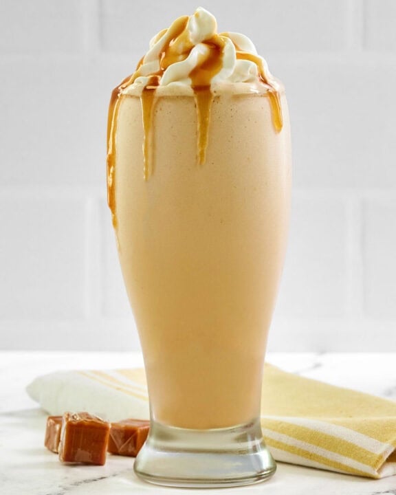 Copycat McDonald's caramel frappe drink on a marble surface.