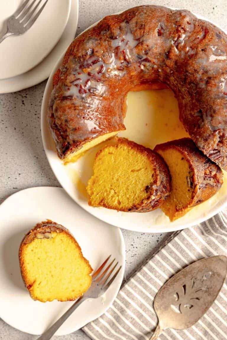 Ms. Bessie's New Orleans rum cake with butter rum glaze on a platter and a slice on a plate.