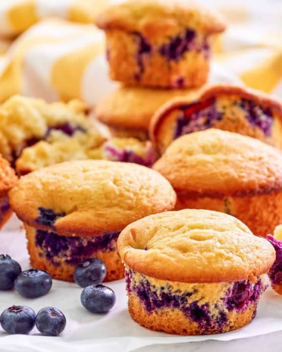 Copycat Otis Spunkmeyer blueberry muffins and fresh blueberries by them.