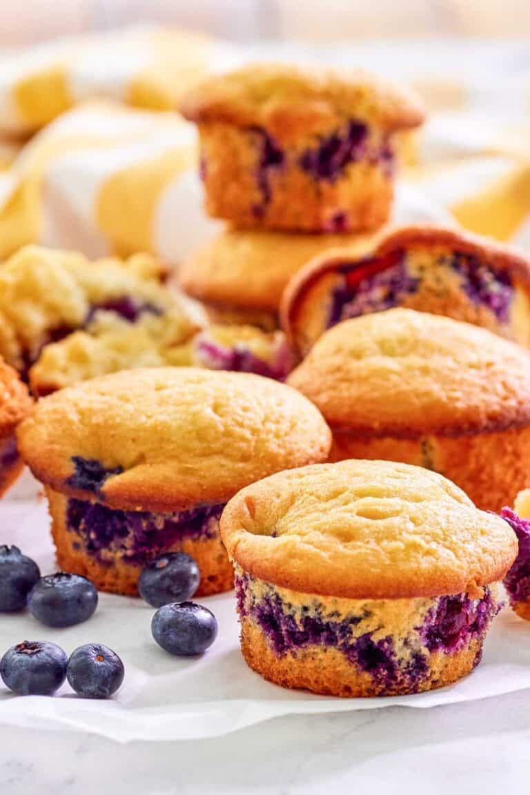 Copycat Otis Spunkmeyer blueberry muffins and fresh blueberries by them.