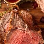 Slices of roast beef on a wood cutting board.