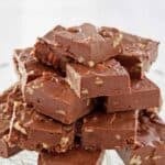 Copycat See's fudge piled on a glass cake stand.