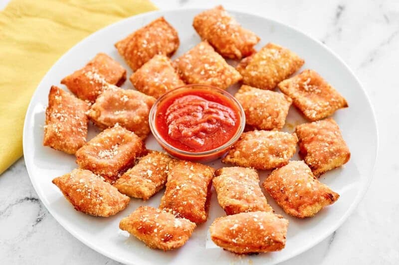 A platter of copycat Totino's pepperoni pizza rolls with marinara.