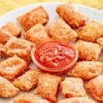 Homemade Totino's pepperoni pizza rolls served with marinara for dipping.