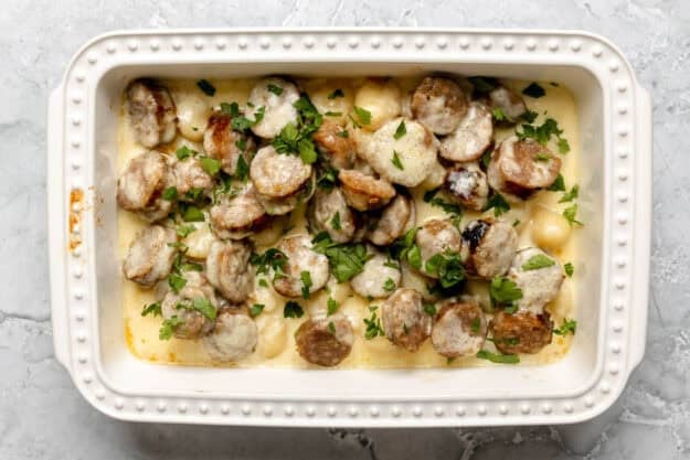 Creamy alfredo sausage and gnocchi bake in a casserole dish.