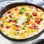 Copycat Black Angus Steakhouse baked potato soup and a spoon in front of it.