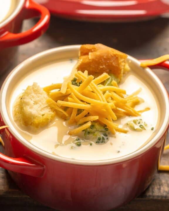 Copycat Black-eyed Pea broccoli cheese soup topped with shredded cheese and croutons.