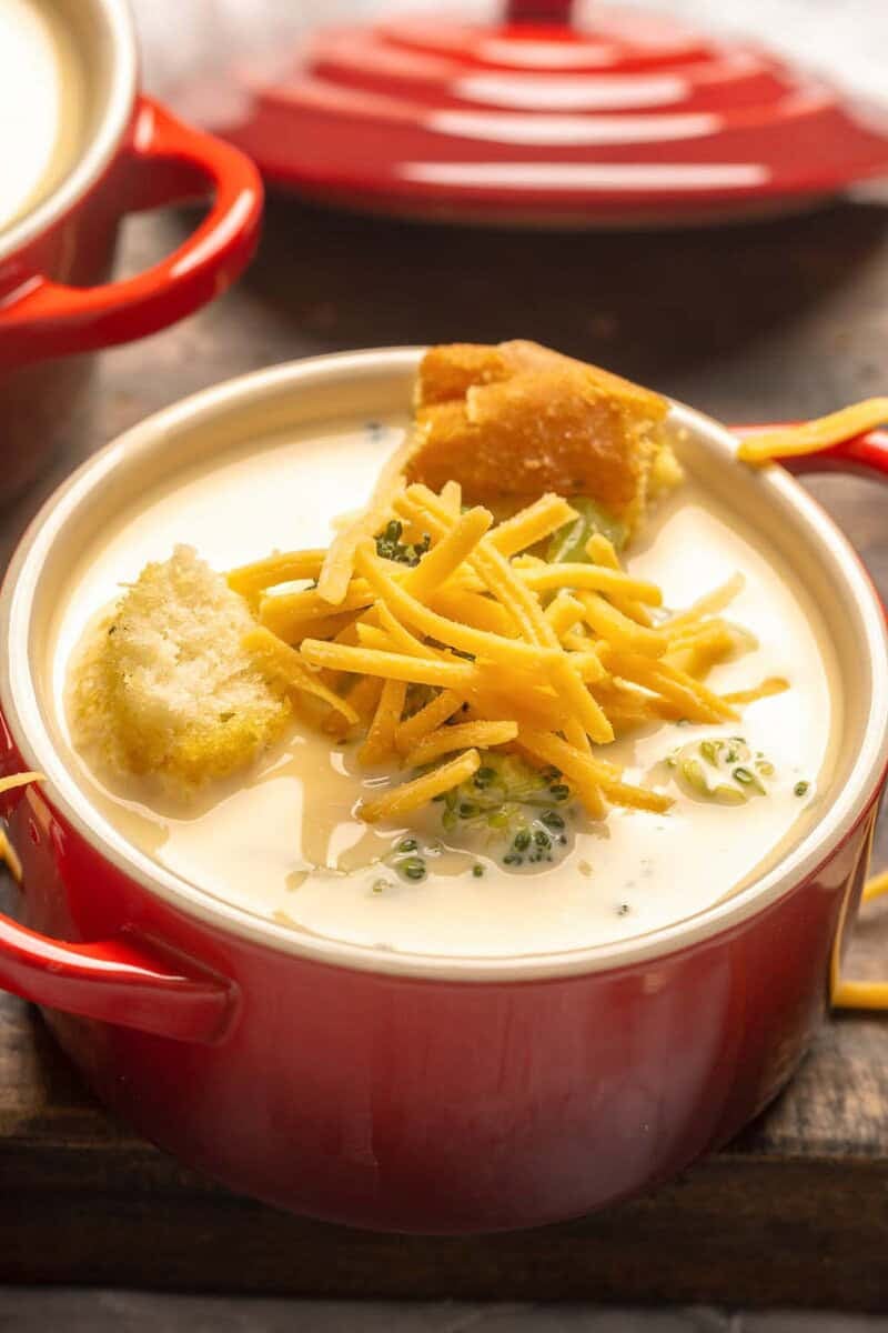 Copycat Black-eyed Pea broccoli cheese soup topped with shredded cheese and croutons.