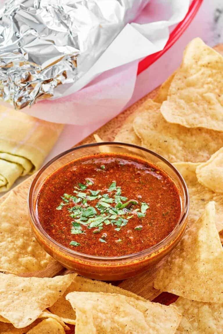 Copycat Chipotle Mexican Grill red chimichurri sauce served with chips and a burrito.