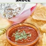 Homemade Chipotle red chimichurri sauce, tortilla chips, and a foil-wrapped burrito.