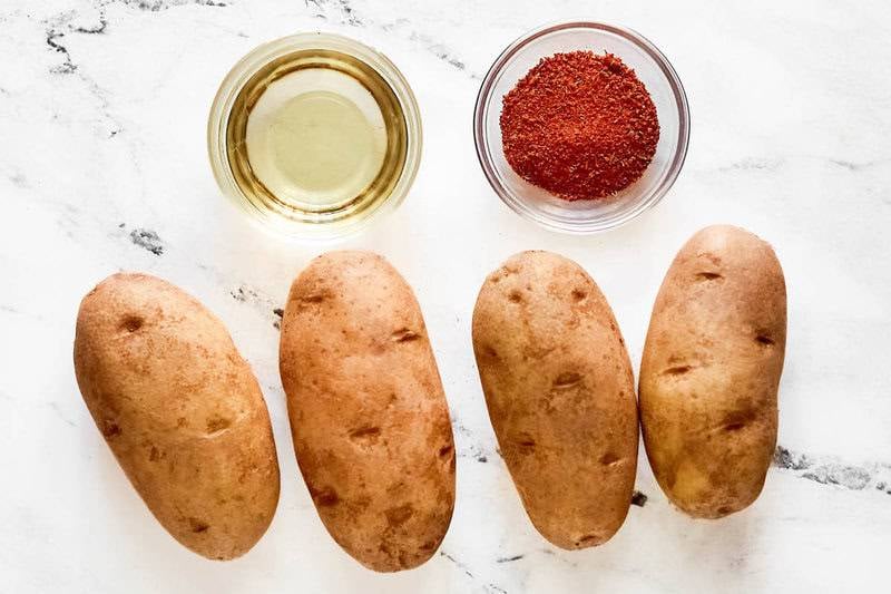 Copycat Five Guys Cajun fries ingredients on a marble surface.
