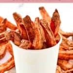 A large cardboard cup filled with homemade Five Guys Cajun fries.