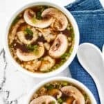 Bowls of homemade Japanese clear soup with mushrooms and scallions.