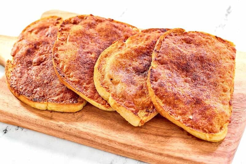 Copycat North Woods Inn garlic cheese bread served on a wood cutting board.