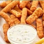 Homemade Skippers tartar sauce on a platter with fish sticks and lemon wedges.