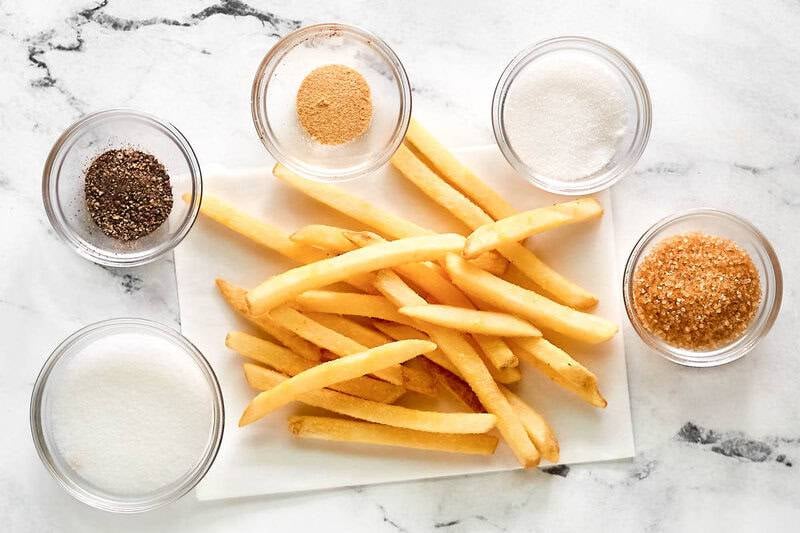 Copycat Wingstop seasoned French fries ingredients on a marble surface.