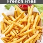 A basket of homemade Wingstop seasoned French fries and a small cup of ketchup behind it.