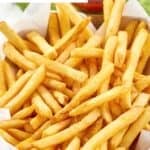 Homemade Wingstop seasoned French fries and a small cup of ketchup.