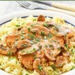 A plate of homemade Cracker Barrel chicken and rice with mushroom gravy.