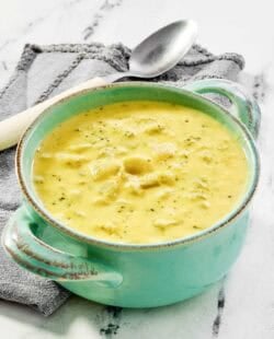 Copycat Jason's Deli broccoli cheese soup in a bowl on a marble surface.