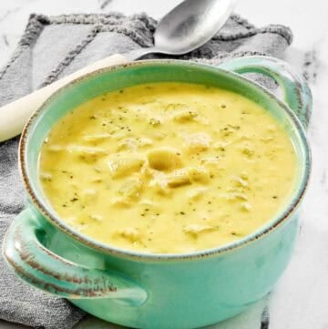 Copycat Jason's Deli broccoli cheese soup in a bowl on a marble surface.
