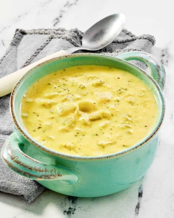 Copycat Jason's Deli broccoli cheese soup in a bowl on a marble surface.