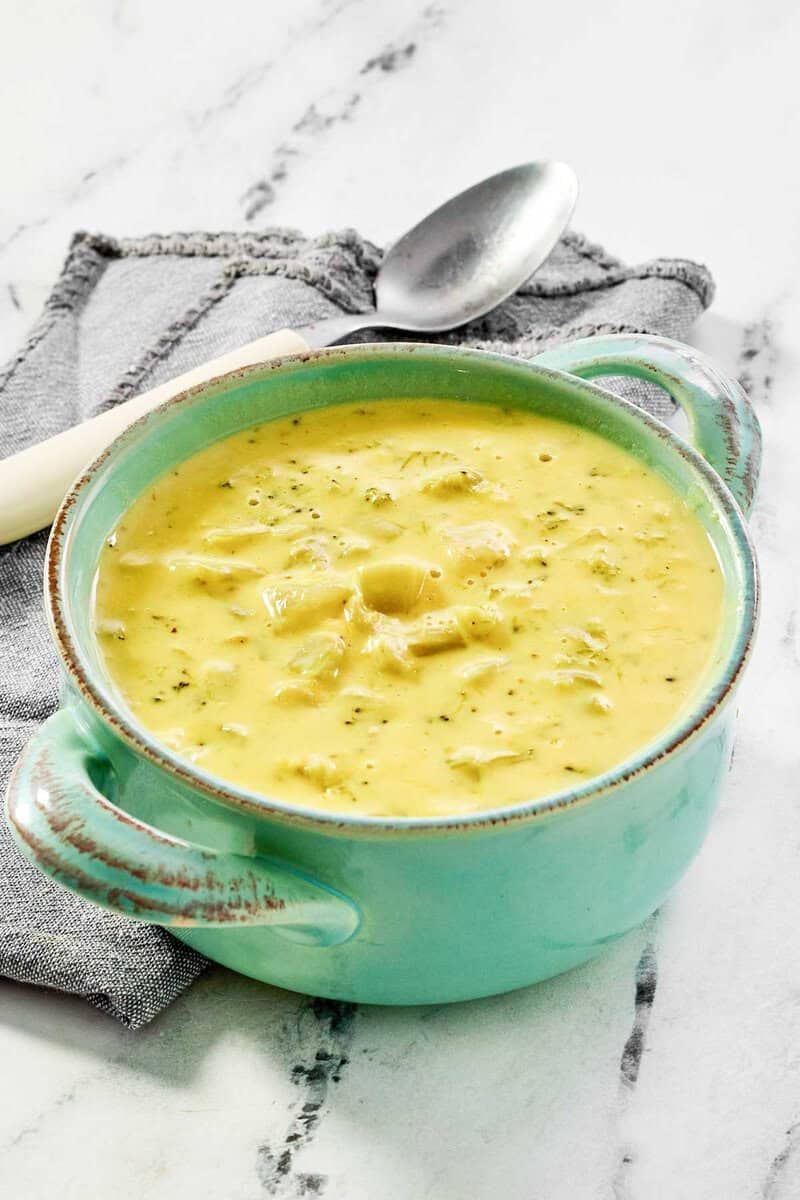 Copycat Jason's Deli broccoli cheese soup in a bowl on a marble surface.