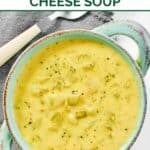 Homemade Jason's Deli broccoli cheese soup in a bowl and a spoon next to it.