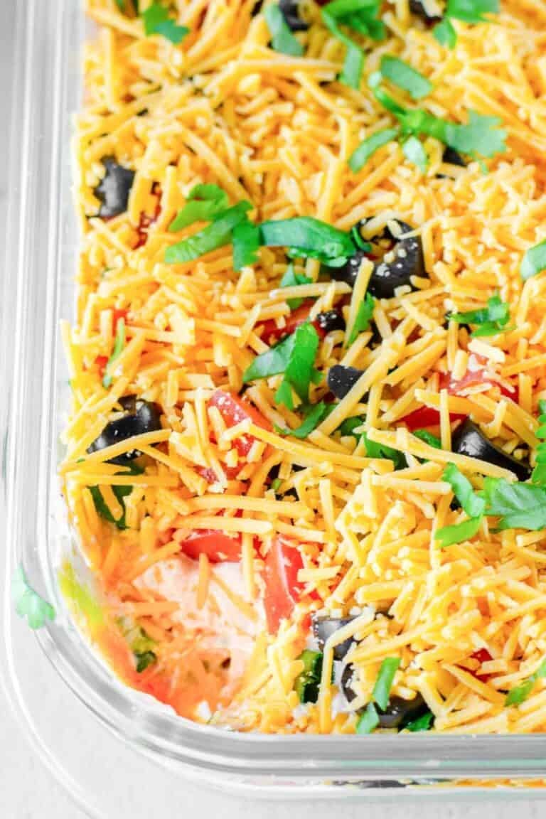 Homemade 7 layer dip in a glass dish.