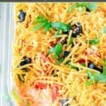 Homemade ultimate 7 layer dip in a glass casserole dish.