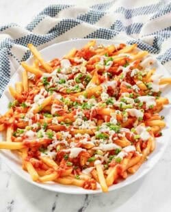 A platter of buffalo fries on a marble surface.